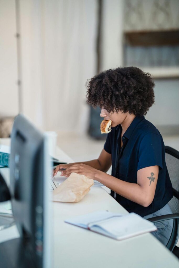 Woman Eating While Working
